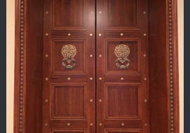 Elevator doors with woodgrained finish and Trompe L'oeil panels.